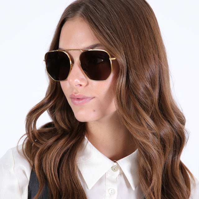 Brunette model wearing Patmos 58 Sunglasses Gold with Brown Flat