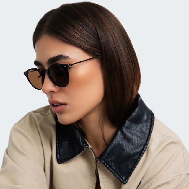 Another angle of woman in a trench coat wearing Portofino Sunglasses Black with Brown