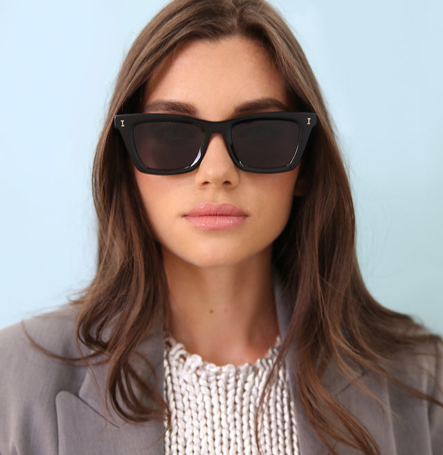 Brunette model wearing coat wearing Portugal Sunglasses Black with Grey Flat