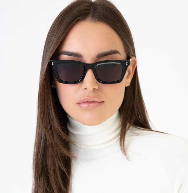 Brunette model with straight hair in a turtle neck wearing Portugal Sunglasses Black with Grey Flat