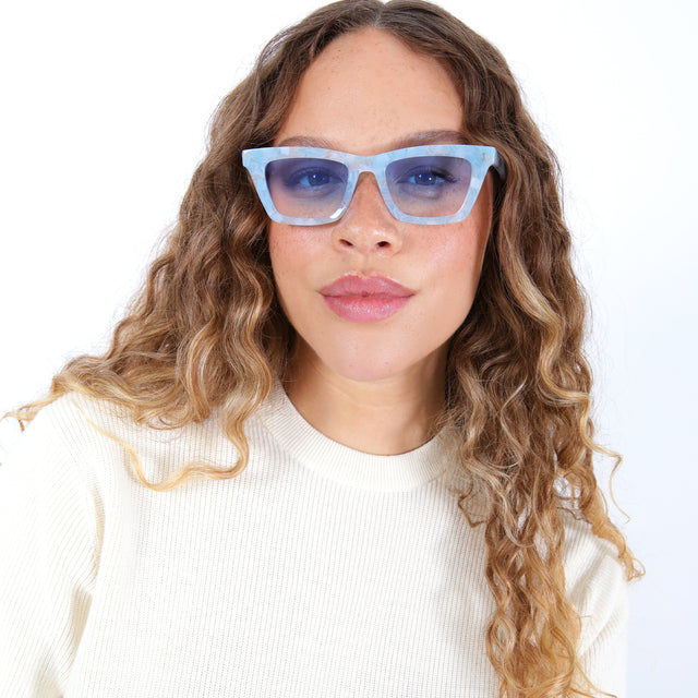 Brunette model with ombré hair wearing Portugal Sunglasses Celeste with Blue Flat Gradient See Through