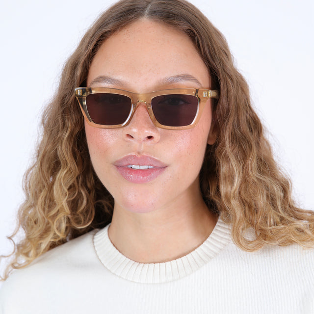 Brunette model with ombré hair wearing Portugal Sunglasses Citrine with Grey Flat