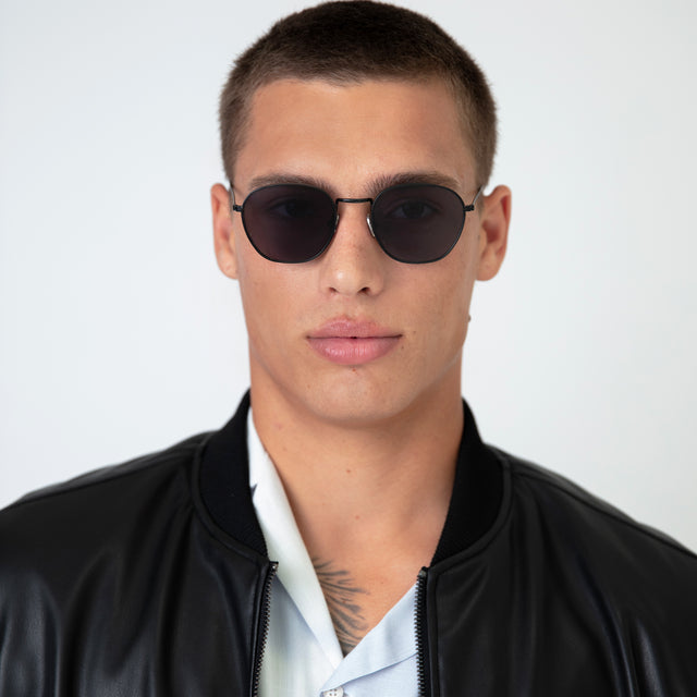 Model with buzzcut hairstyle wearing Prince Sunglasses Black with Grey Flat