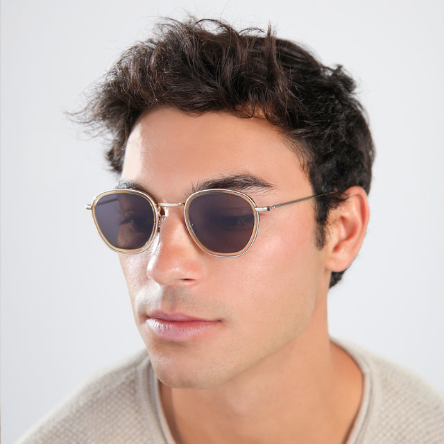 Man in a beige waffled sweatshirt wearing Prince Tate Sunglasses Citrine/Gold with Grey Flat