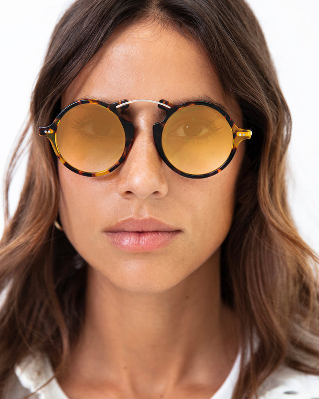 Brunette model with wavy hair wearing Roma II Sunglasses Star Tortoise with Gold Flat Mirror Gradient