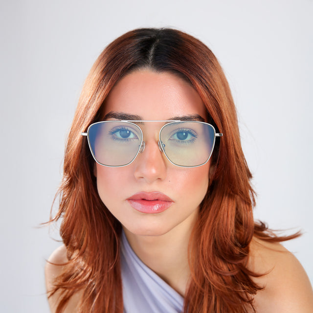 Woman with red hair in a blue blouse wearing Samos Sunglasses Silver with Mint Flat See Through