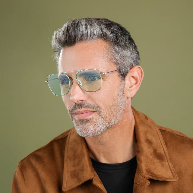 Man with salt and pepper hair and beard wearing Samos Sunglasses Silver with Mint Flat See Through