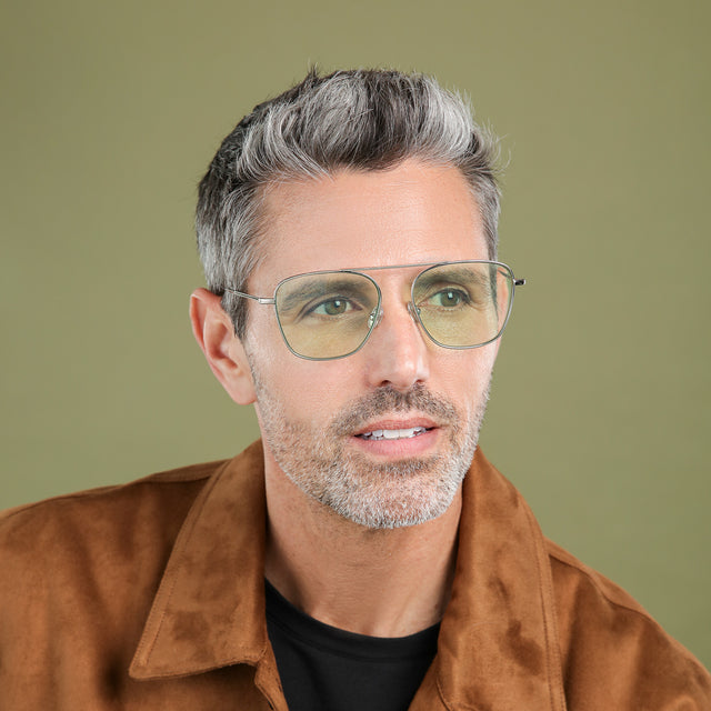 Man with salt and pepper hair and beard looking to his left wearing Samos Sunglasses Silver with Mint Flat See Through