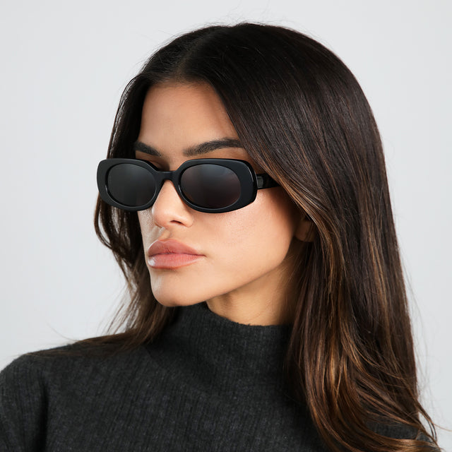 Model in dark gray turtleneck looking to her right wearing Shirley 51 Sunglasses Black with Grey