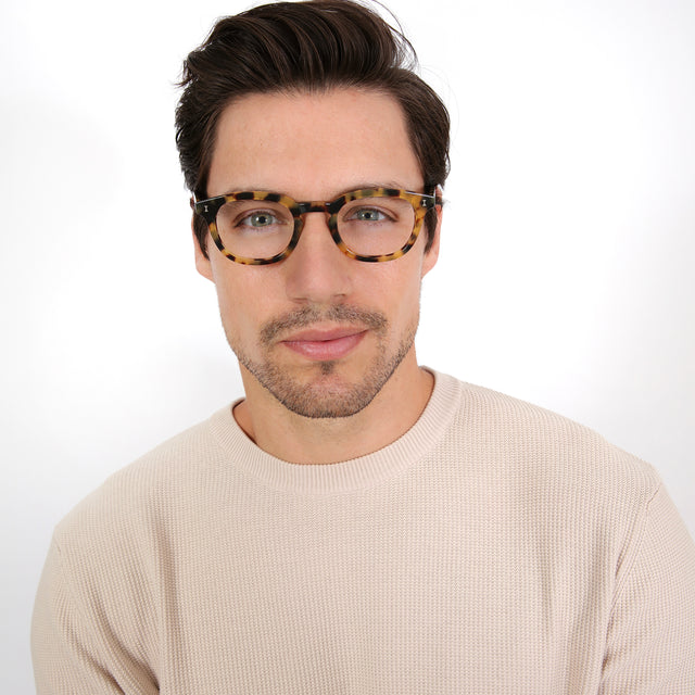 Model with brown hair combed sideways wearing Slope Optical Tortoise Optical