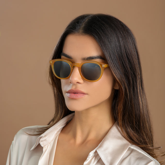 Another angle of brunette woman looking to her right wearing Slope Sunglasses Honey Gold with Olive