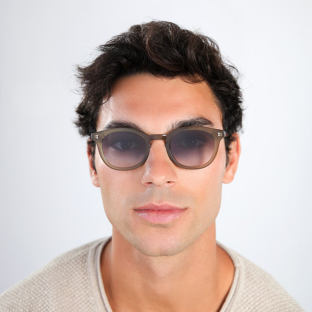 Man with brown hair wearing Slope Sunglasses Olive with Grey Gradient