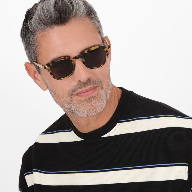 Male model looking left wearing Slope Sunglasses Tortoise with Grey