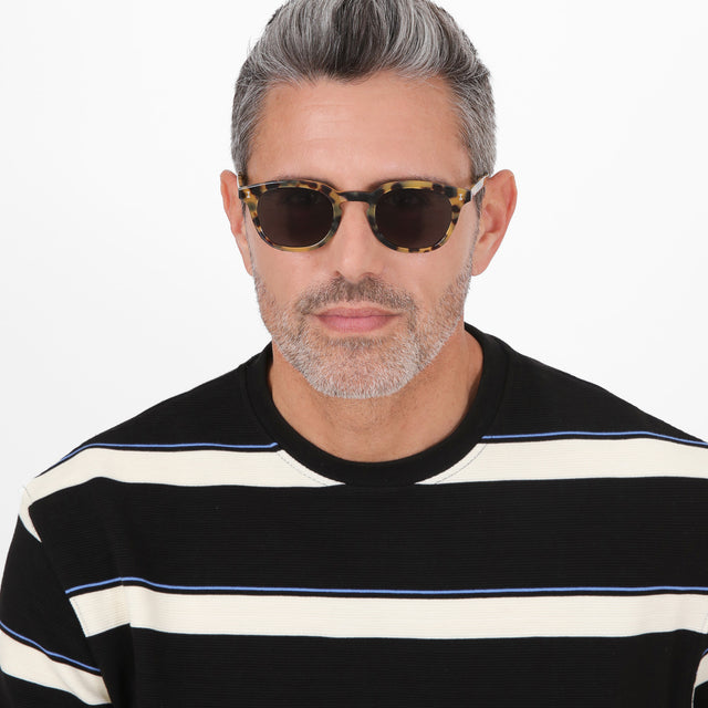 Model with salt and pepper hair and beard wearing Slope Sunglasses Tortoise with Grey