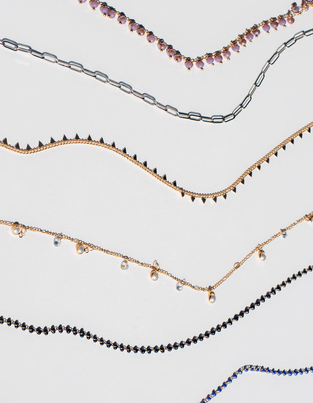 Six sunglass chains from our newest collection displayed on a white countertop