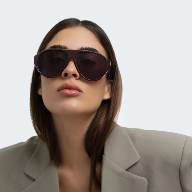 Woman in a blazer wearing Telluride Sunglasses Bordeaux with Grey