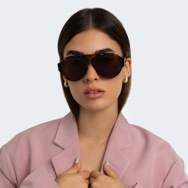 Woman in a pink blazer wearing Telluride Sunglasses Havana with Brown