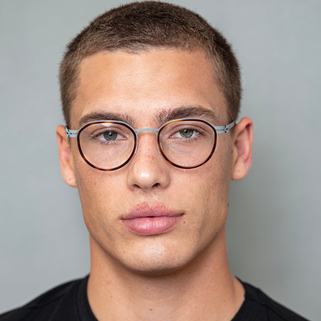 Model with buzzcut hairstyle wearing Tompkins Titanium Optical Havana/Matte Gunmetal Optical