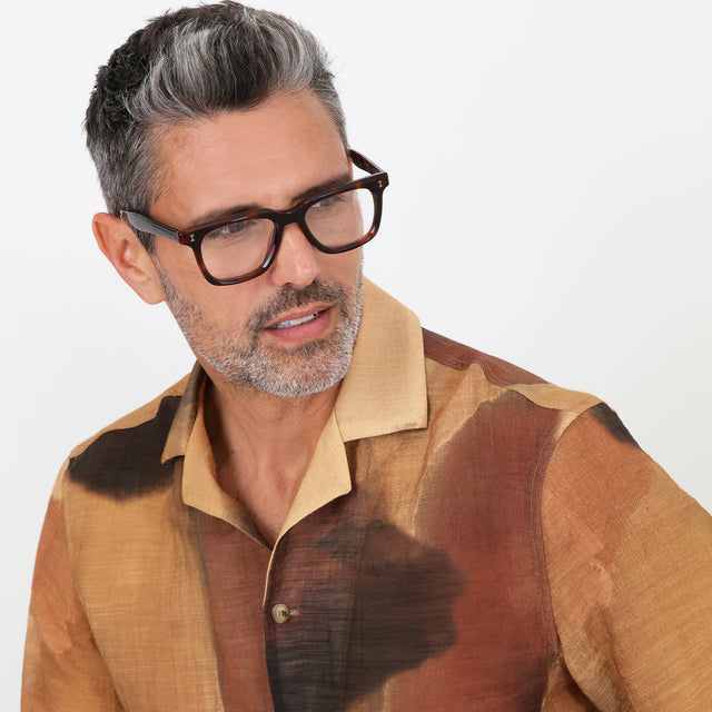 Model with salt and pepper hair and beard wearing Toscana Optical Havana Optical