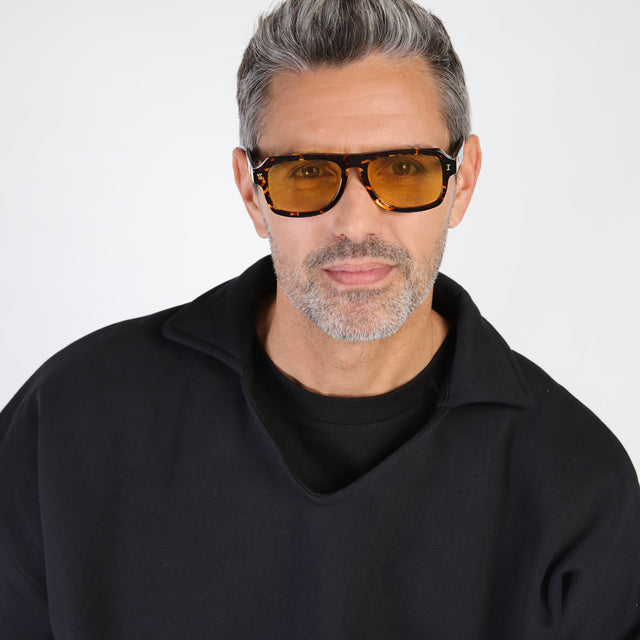 Model with salt and pepper hair and beard wearing Trancoso Sunglasses Star Tortoise with Honey See Through