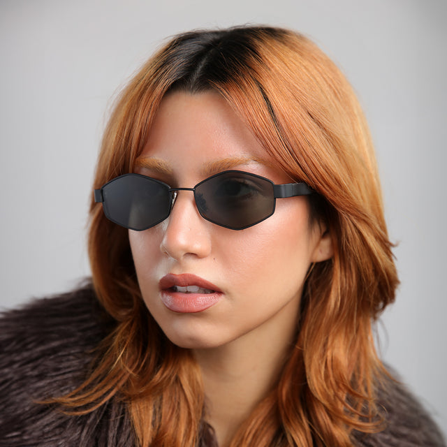 Close up of model with red hair wearing Tucson Sunglasses Matte Black with Grey