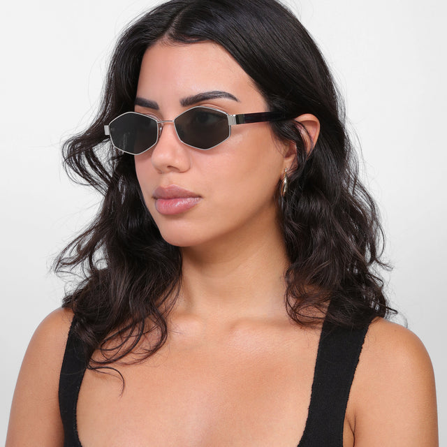 Brunette model looking right wearing Tucson Sunglasses Silver/Winter with Grey