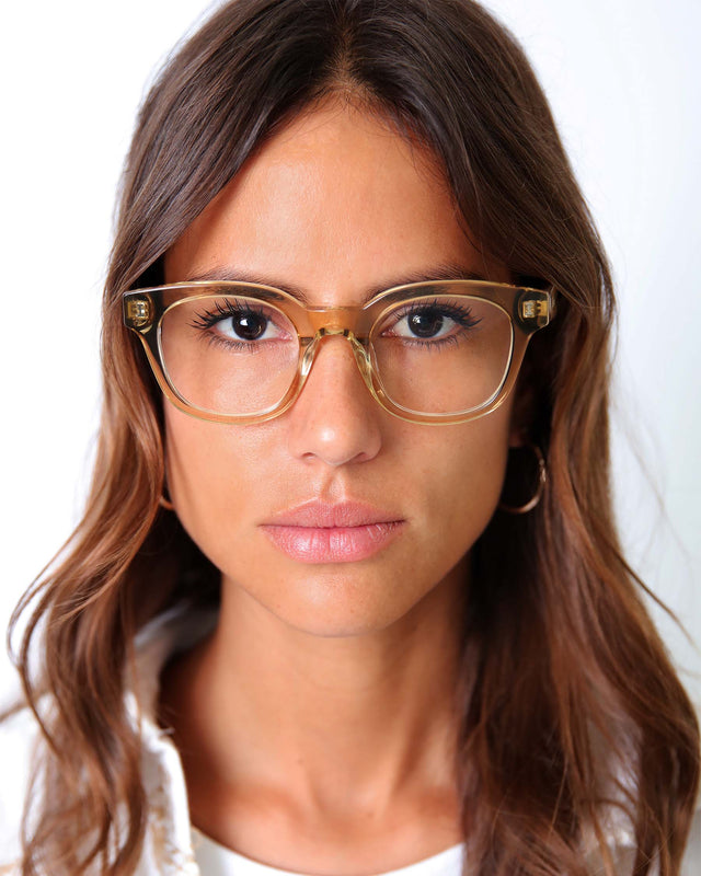 Brunette model with wavy hair wearing Vail Optical Citrine Optical