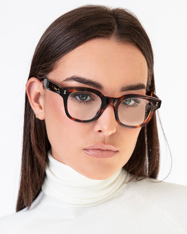 Brunette model with straight hair wearing Vail Optical Havana Optical