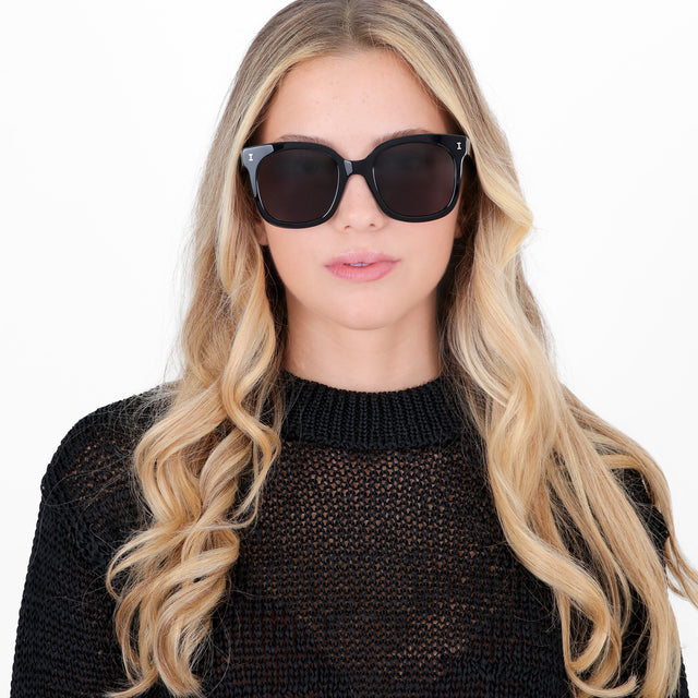 Blonde model wearing Valencia Sunglasses Black with Grey