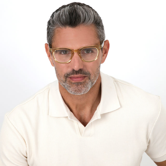 Model with salt and pepper hair and beard wearing Veneto Optical Citrine Optical