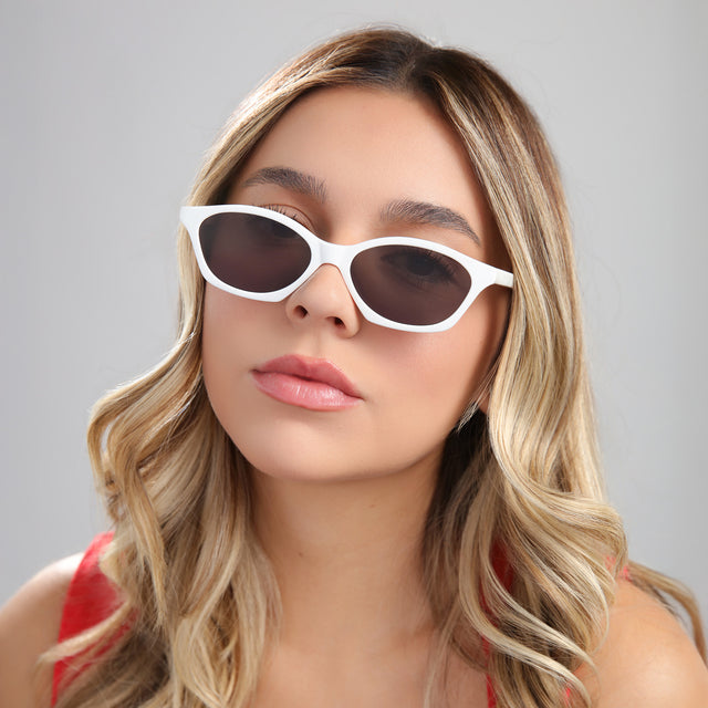 Another angle of blond woman wearing Vilma Sunglasses Light Grey with Grey