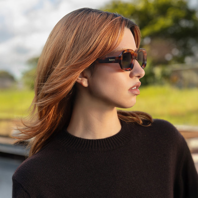 Side profile of model wearing Vinyl Sunglasses Havana with Grey