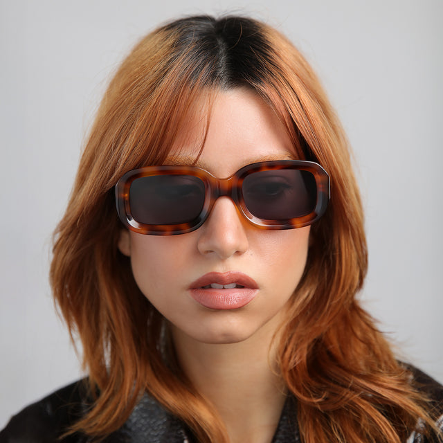 Another angle of model with red hair wearing Vinyl Sunglasses Havana with Grey