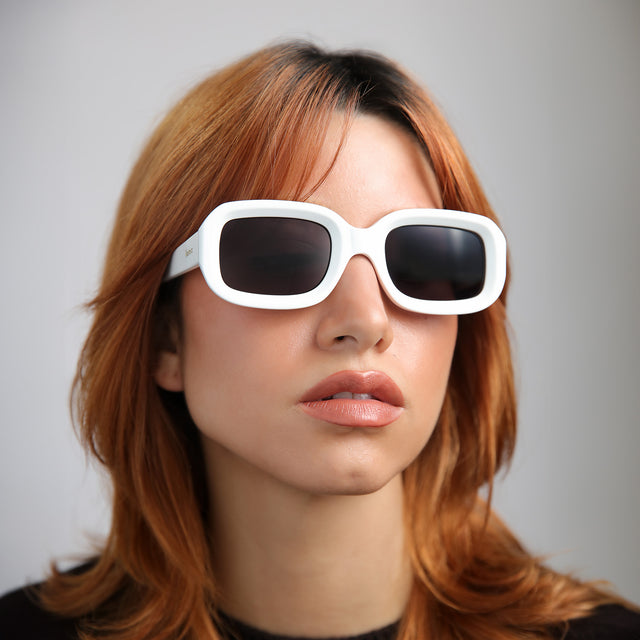 Another angle of model with red hair wearing Vinyl Sunglasses White with Grey