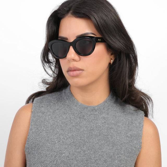 Brunette model looking right wearing Wellington Sunglasses Black with Grey