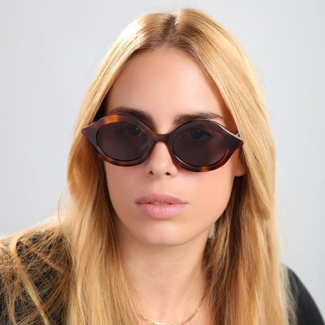 Another angle of blond woman in a black tee wearing Willow Sunglasses Havana with Grey