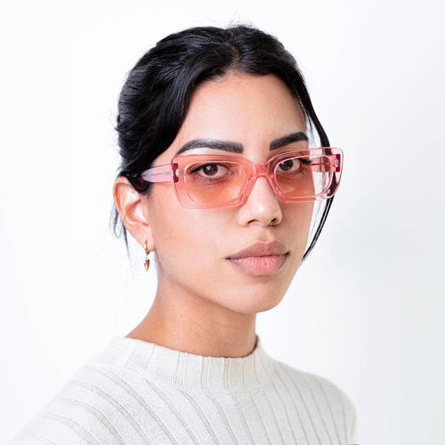 Brunette model wearing Wilson Sunglasses Neon Pink with Neon Pink Flat See Through