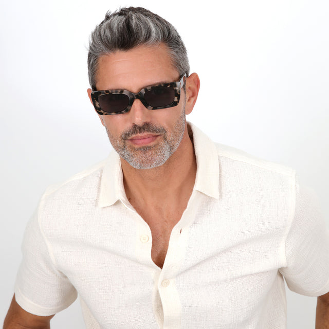 Male model in a linen shirt wearing Wilson Sunglasses White Tortoise with Grey Flat