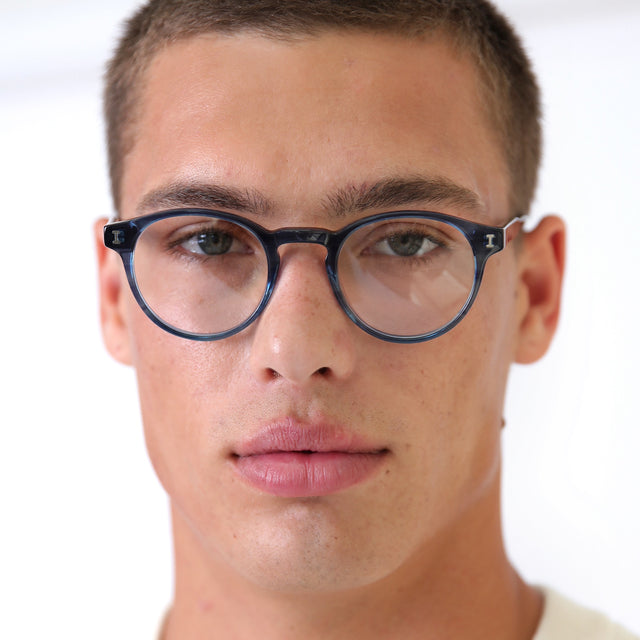 Model with buzzcut style haircut wearing Wyoming Optical Aegean Blue Optical