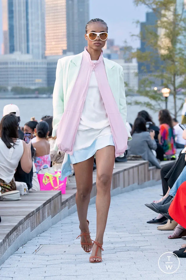 Woman in a pastel green and pink jacket walking the catwalk wearing Cynthia Rowley