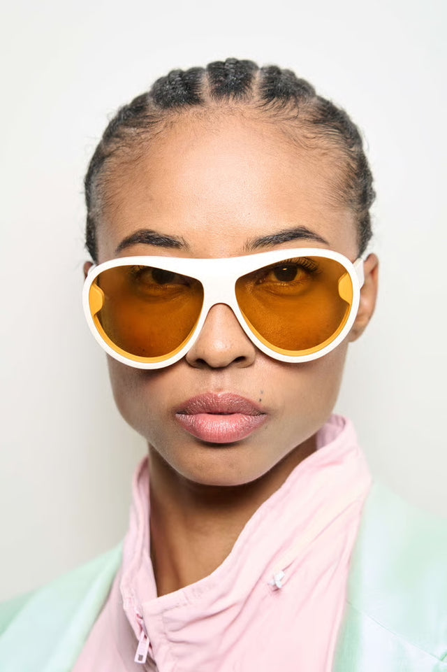 Close up of model in Cynthia Rowley x illesteva Sunglasses in Cream