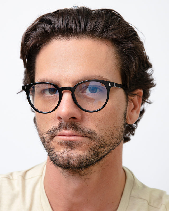 Model with brown hair combed back wearing Dakota Optical Black Optical