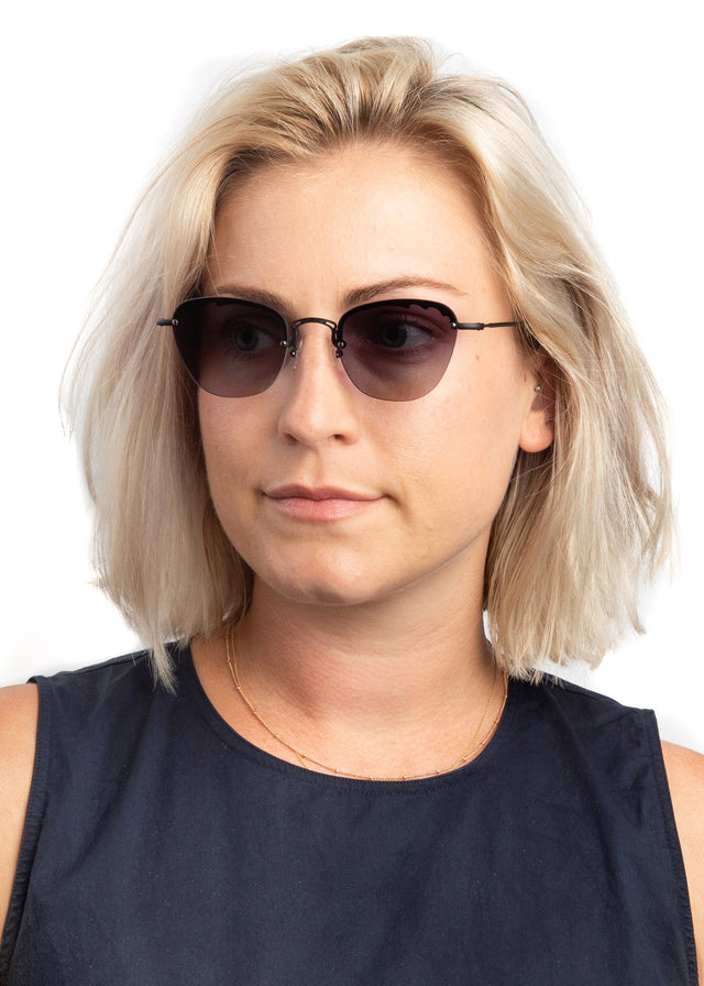 Blonde model with shoulder-length straight hair Sorrento Sunglasses side view in Matte Black / Grey Flat Gradient Lenses