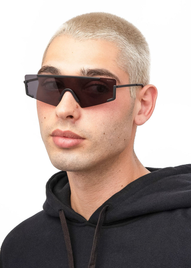 Model with blonde buzzcut wearing Morph Sunglasses Matte Black with Grey