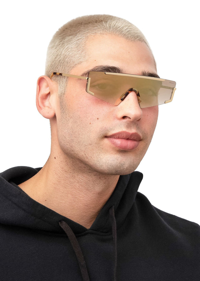 Model with blonde buzzcut wearing Morph Sunglasses Gold Tortoise with Gold Mirror Gradient