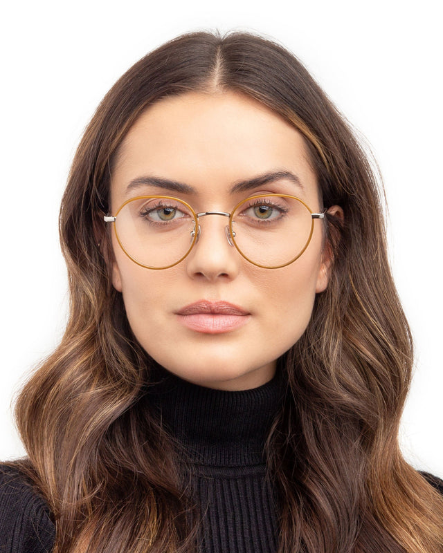 Brunette model with wavy hair wearing Oxford 52 Optical Oak/Silver Optical