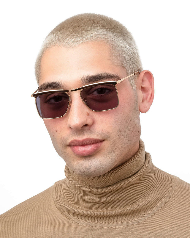 Model with blonde buzzcut wearing PCH Sunglasses Rose Gold with Grey Flat