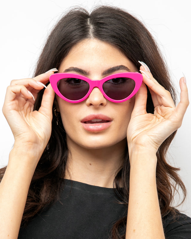Brunette model with wavy hair wearing Pamela Sunglasses Hot Pink with Grey Flat