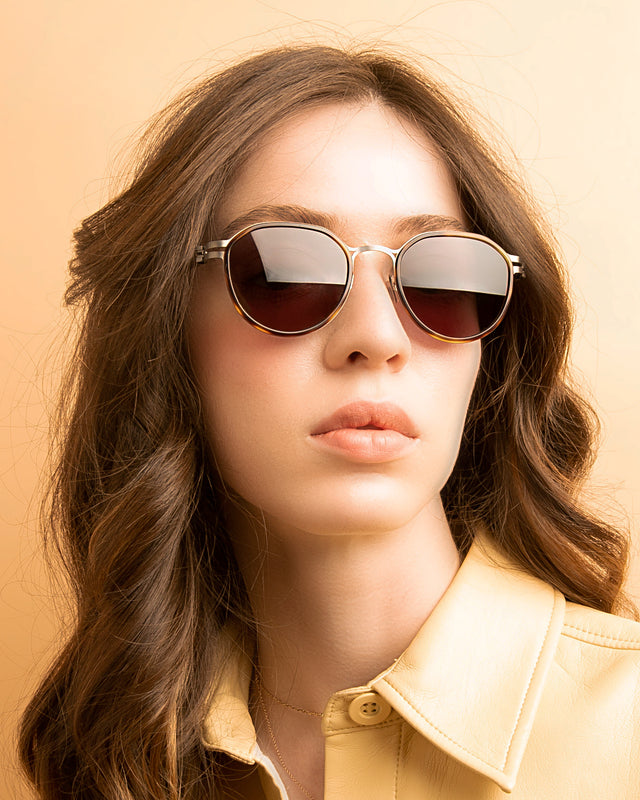 Brunette model with wavy hair wearing Tompkins Titanium Sunglasses Tortoise/Matte Silver with Grey