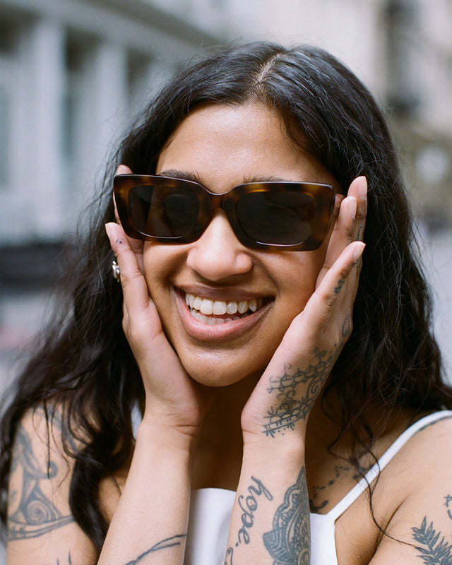 Brunette model with wavy hair wearing Wilson Sunglasses Havana with Grey Flat